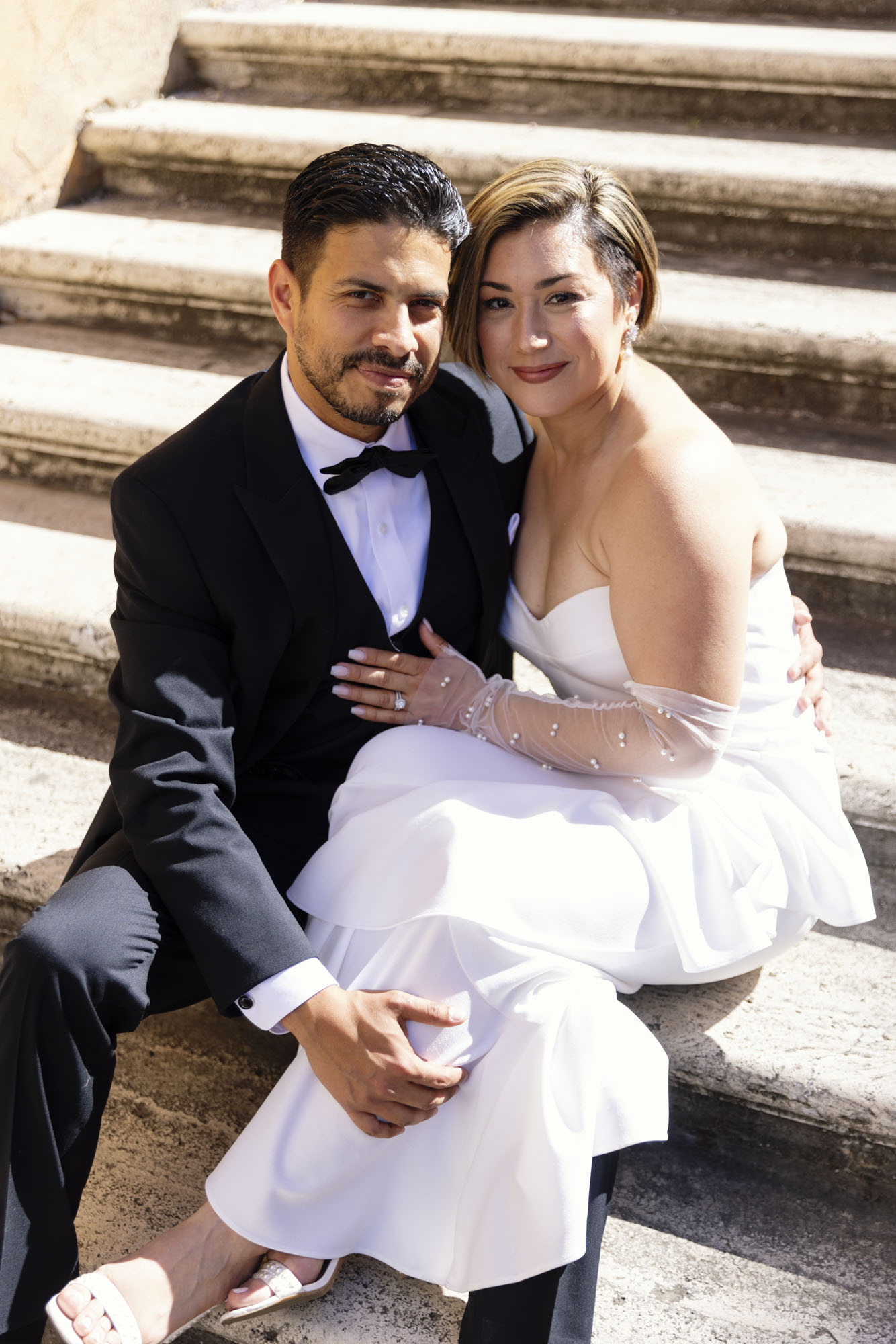 portrait of wedding couple sitting on the Spanish steps