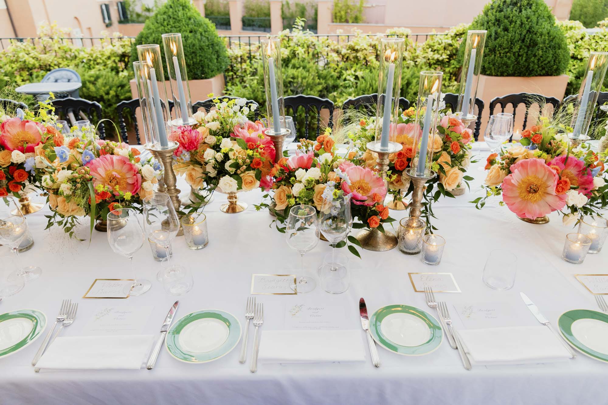 details of vow renewal long table with flowers and candles at hotel de la ville