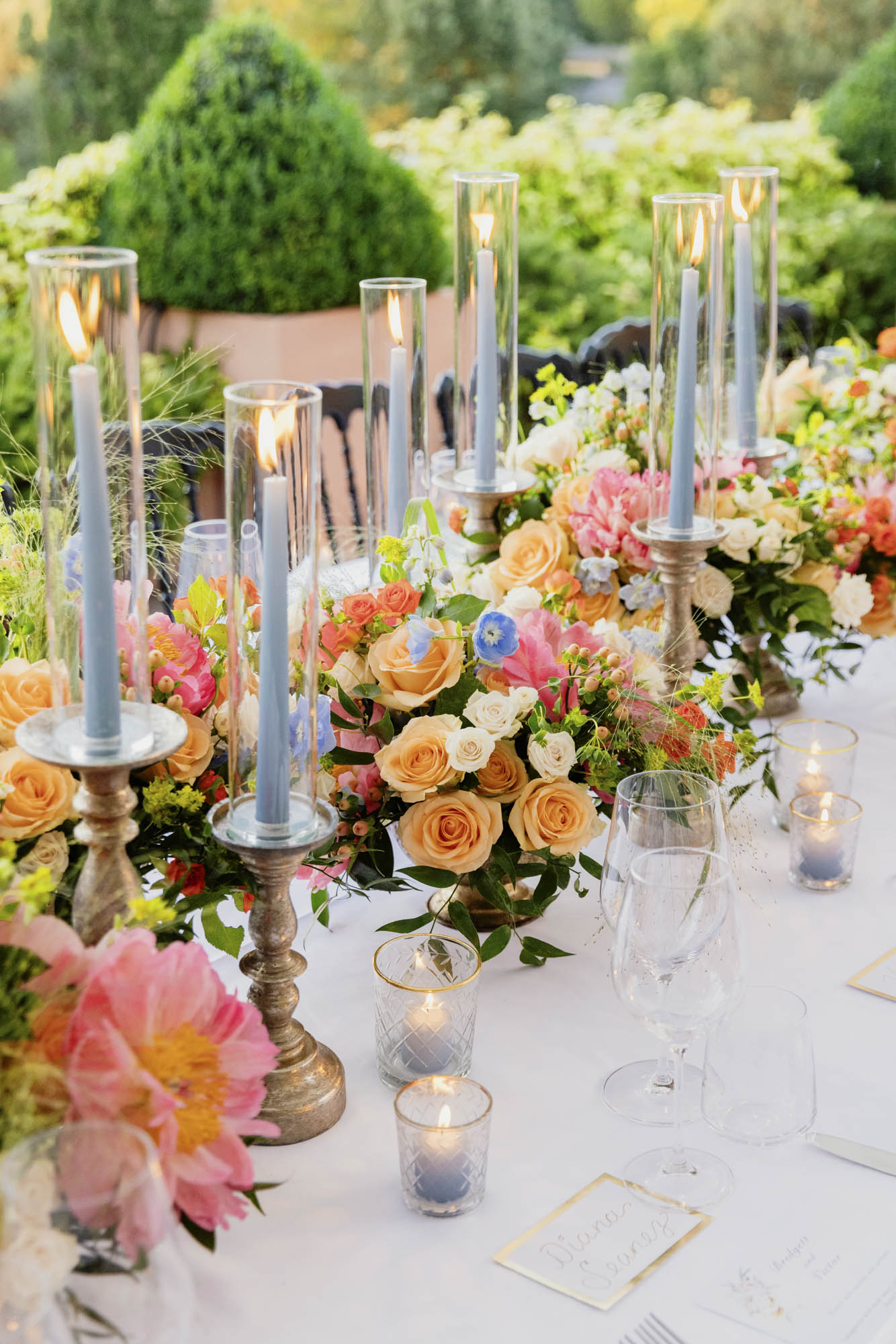 table decor with flowers and candles on vow renewal table at hotel de la ville