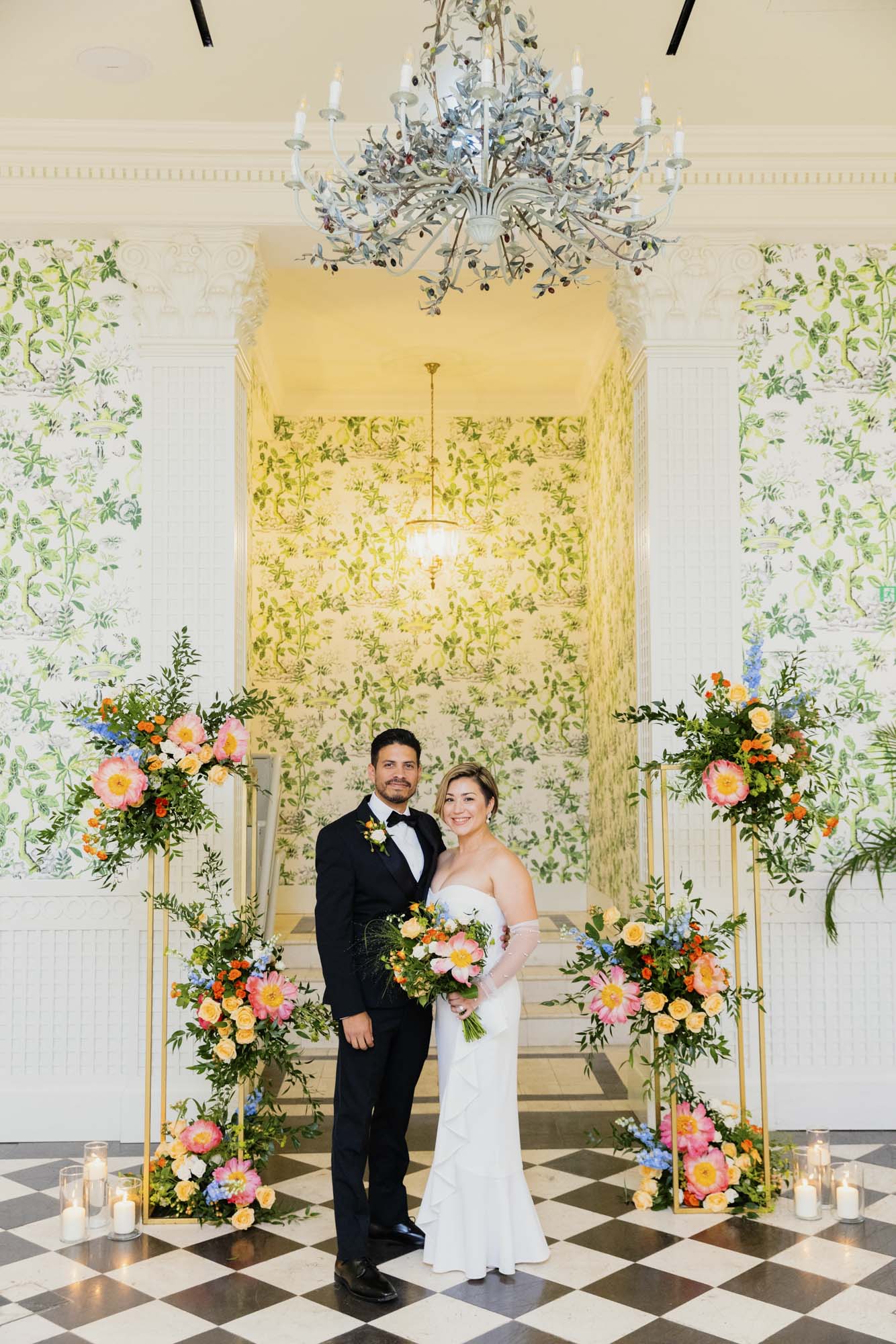 couple posing near flowers decor at the end of vow renewal ceremony